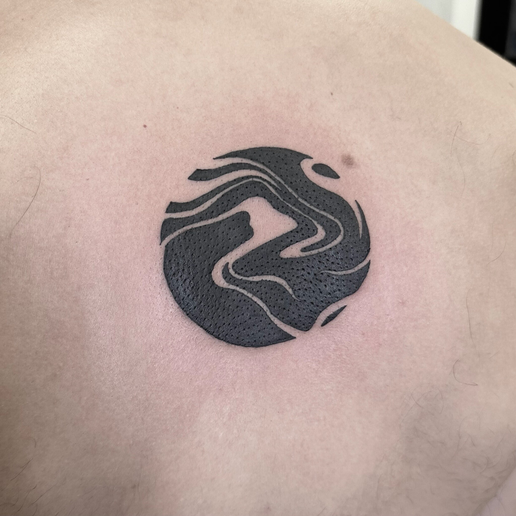 Tatouage cercle noir minimaliste par Aurélie à Lausanne