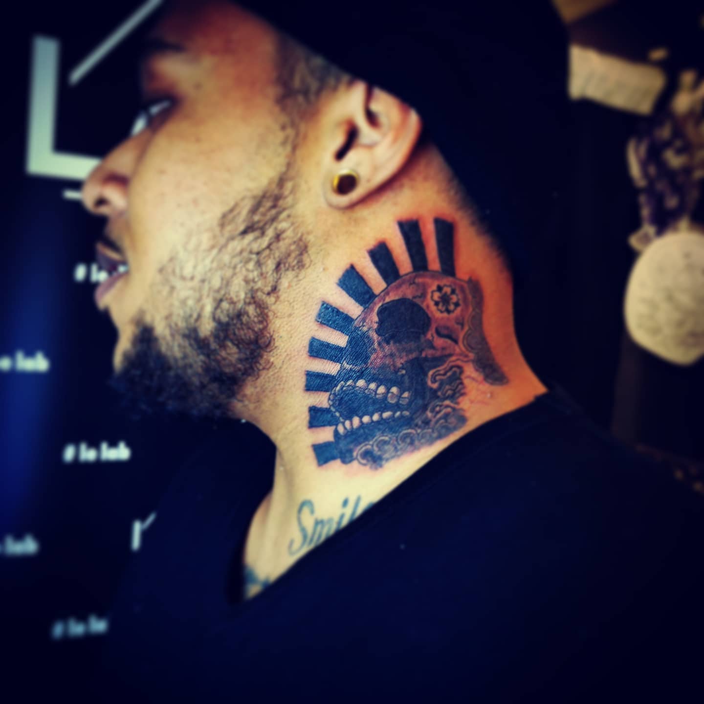 Neck skull tattoo